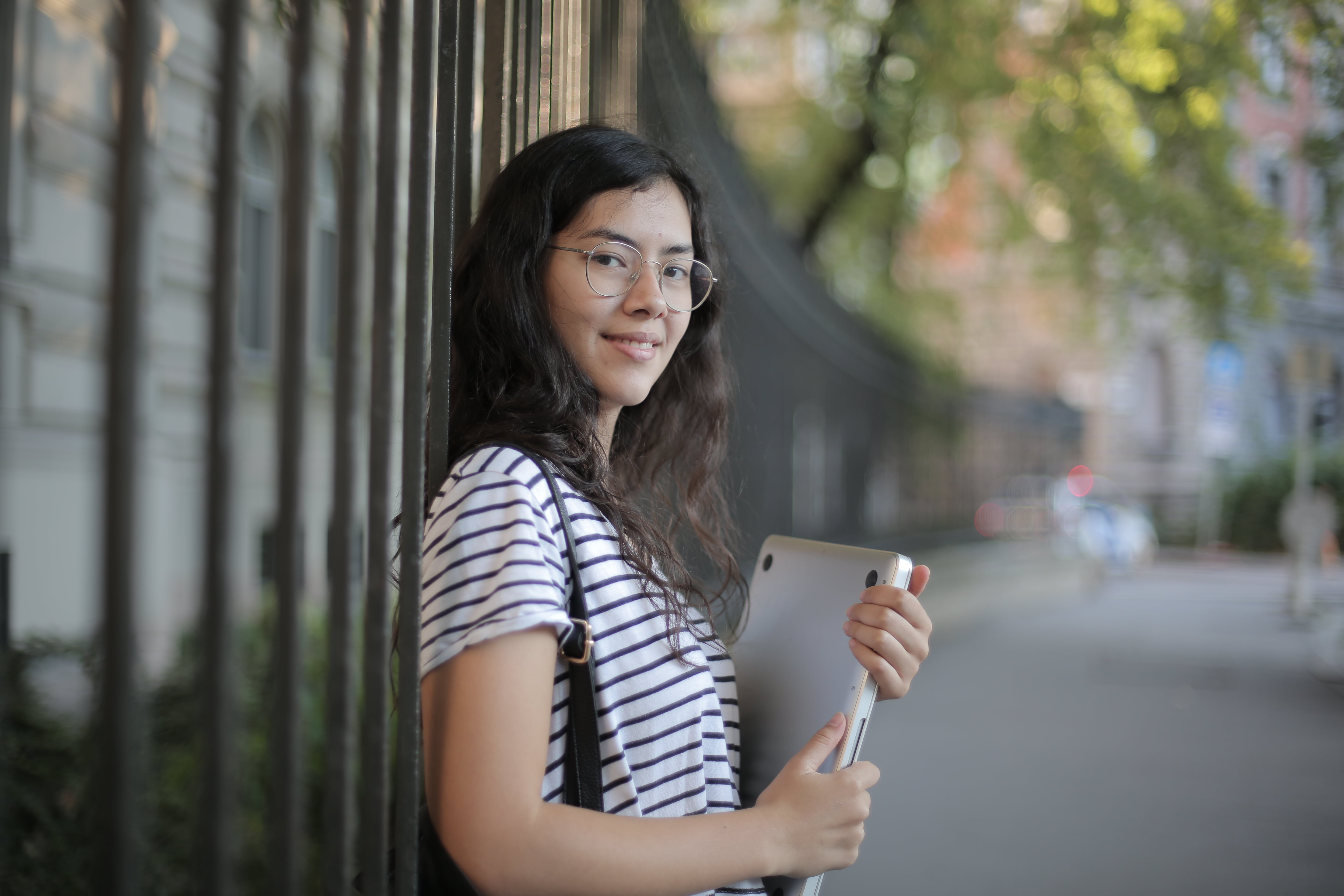 Photo by Andrea Piacquadio: https://www.pexels.com/photo/woman-in-black-and-white-striped-shirt-holding-laptop-3808811/